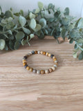 Bracelet Corail Fossile 6mm, pierres naturelles polies Collection Pierre d’Exception, bijou rouge orangé pour énergie et protection.